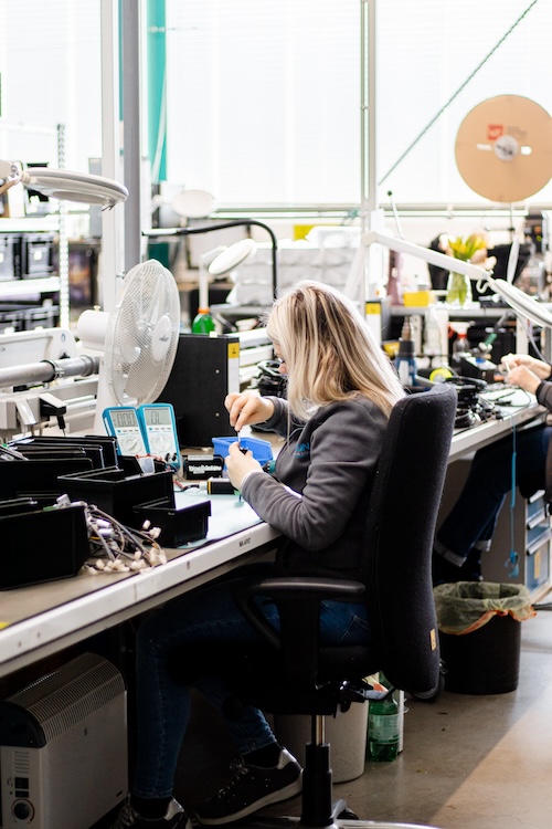 Woman working at a modern workplace in a production or electronics manufacturing environment