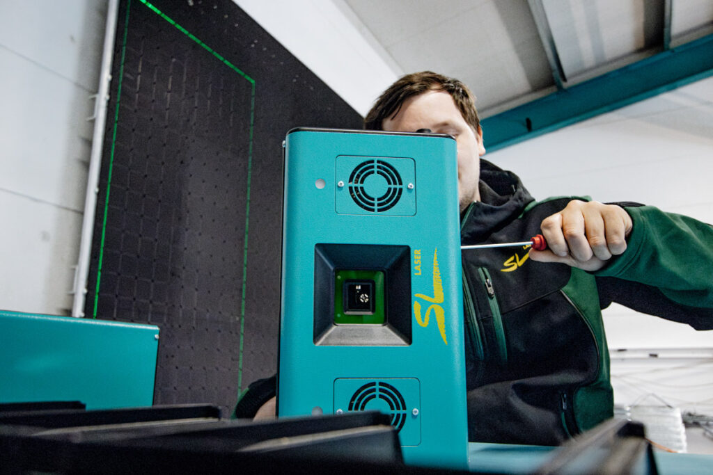 Technician installs an SL laser device and makes precise adjustments to the housing.